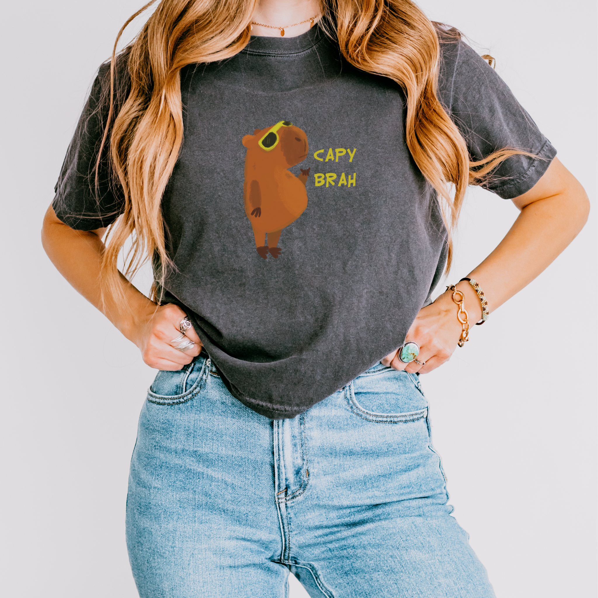 A gray boxy fit t-shirt featuring a graphic of a capybara with the text 'CAPY BRAH' on the front.