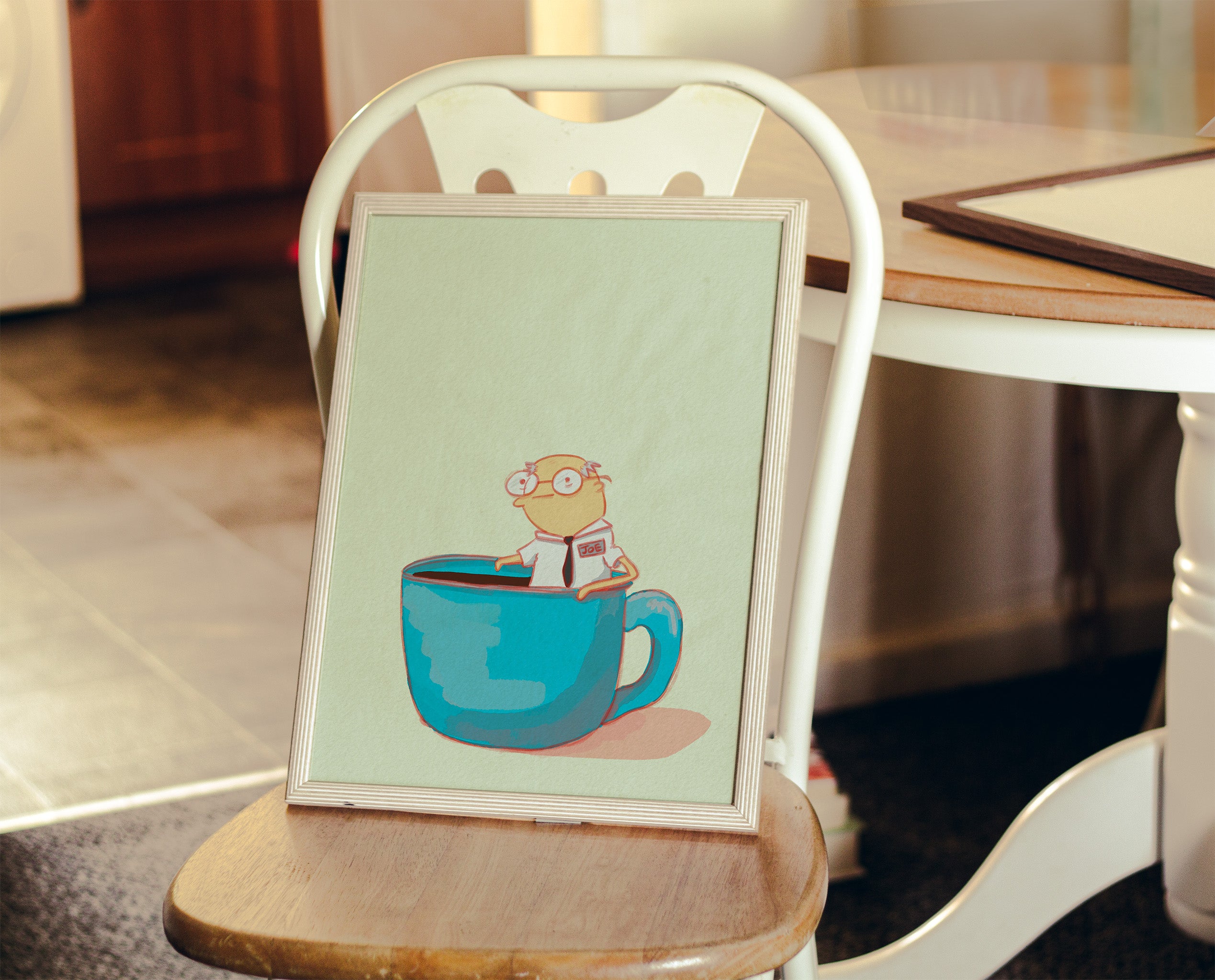 whimsical coffee art with a literal cup of joe illustration is displayed on a kitchen chair