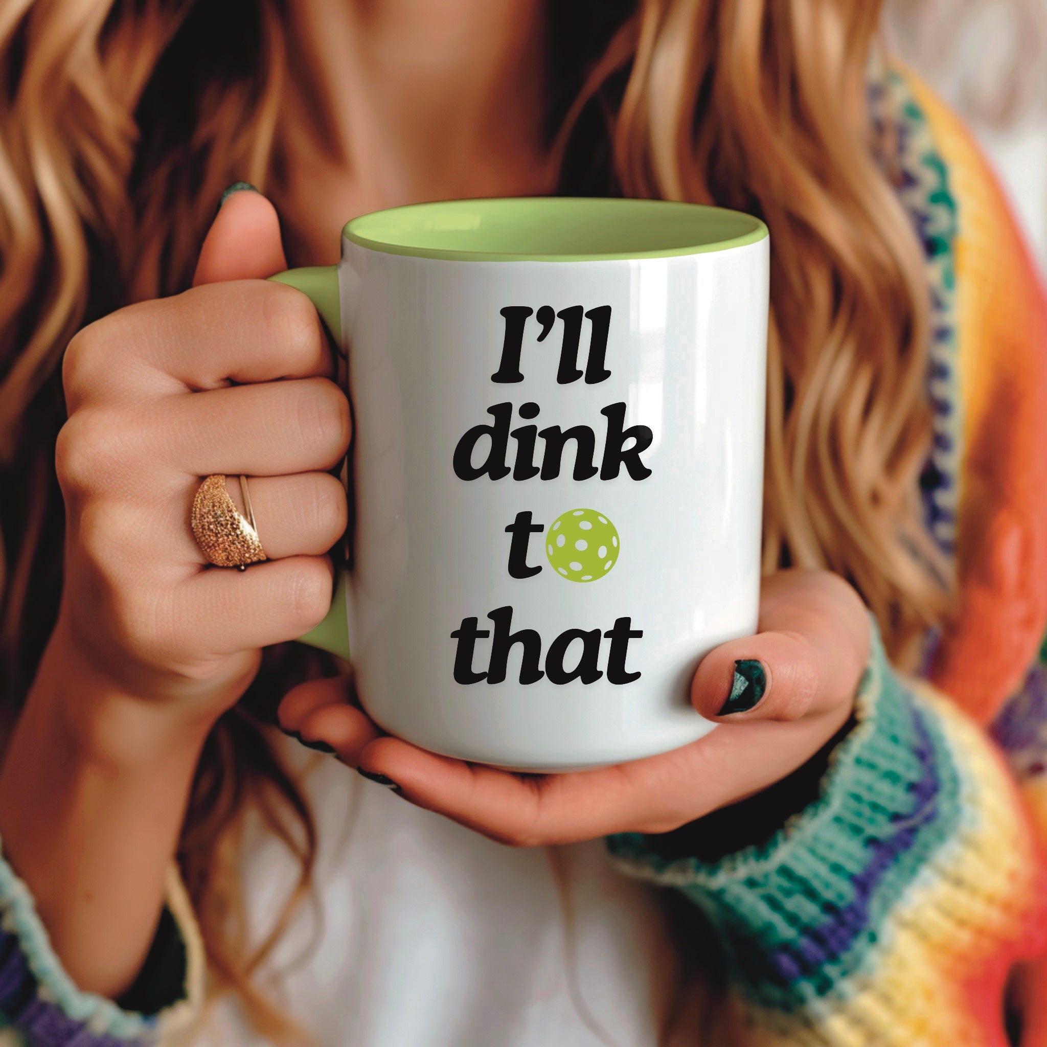 view of woman holding a pickle ball mug with a funny quote that says "I'll dink to that" with illustration of a green pickle ball
