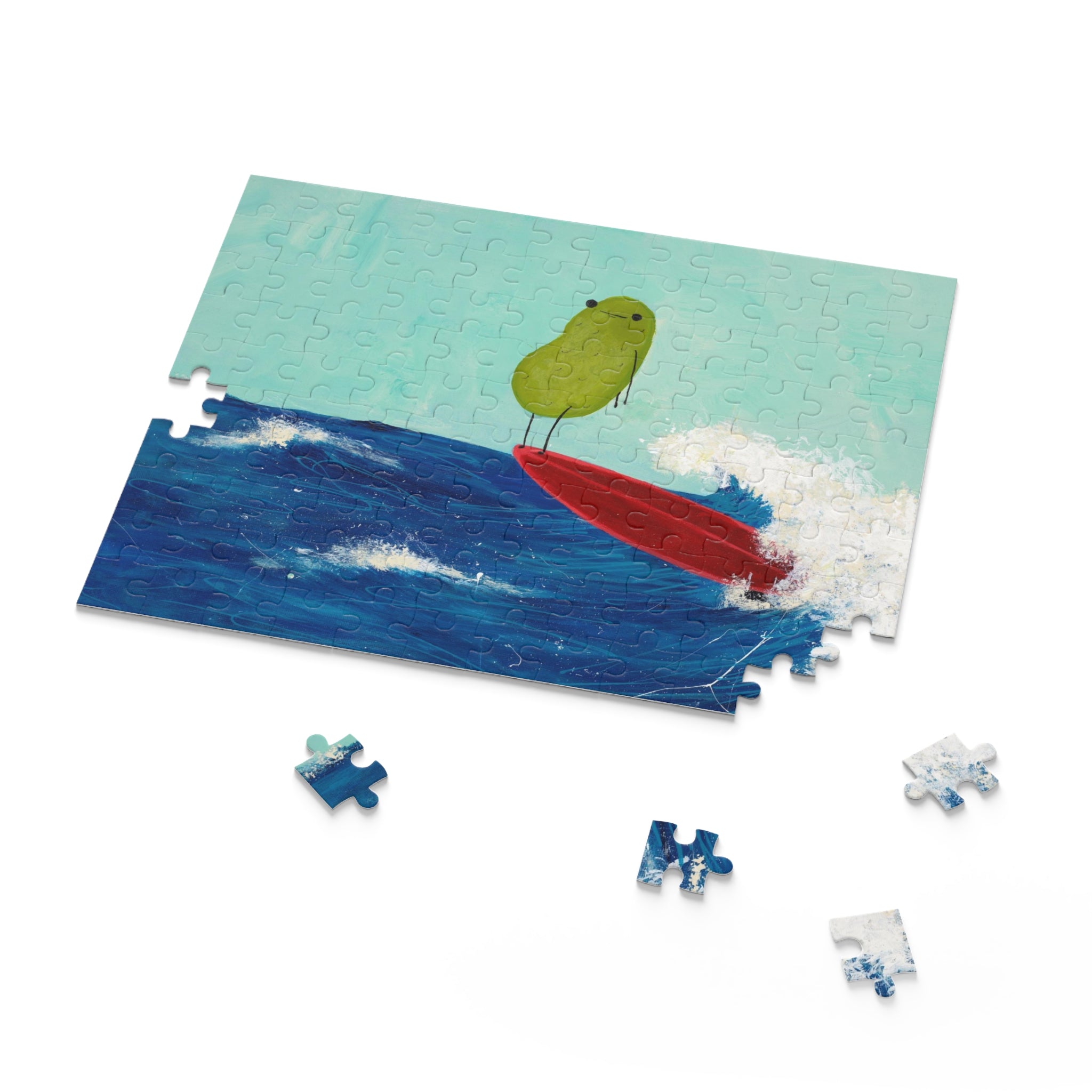 Image of a beach themed jigsaw puzzle that contains a whimsical image of a surfing pickle