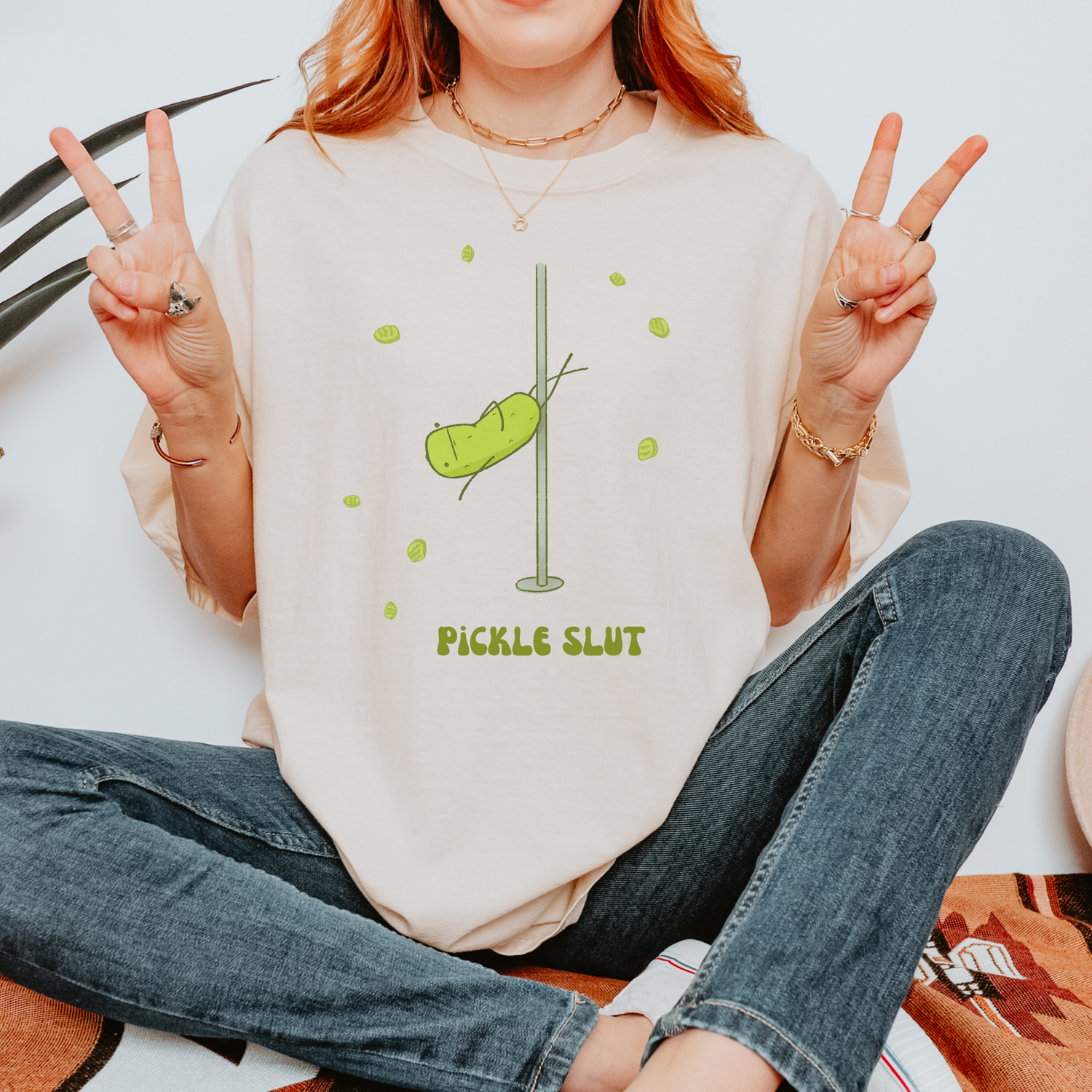 woman in tinted glasses wearing tshirt with funny pole dancing pickle graphic with text that reads "pickle slut"