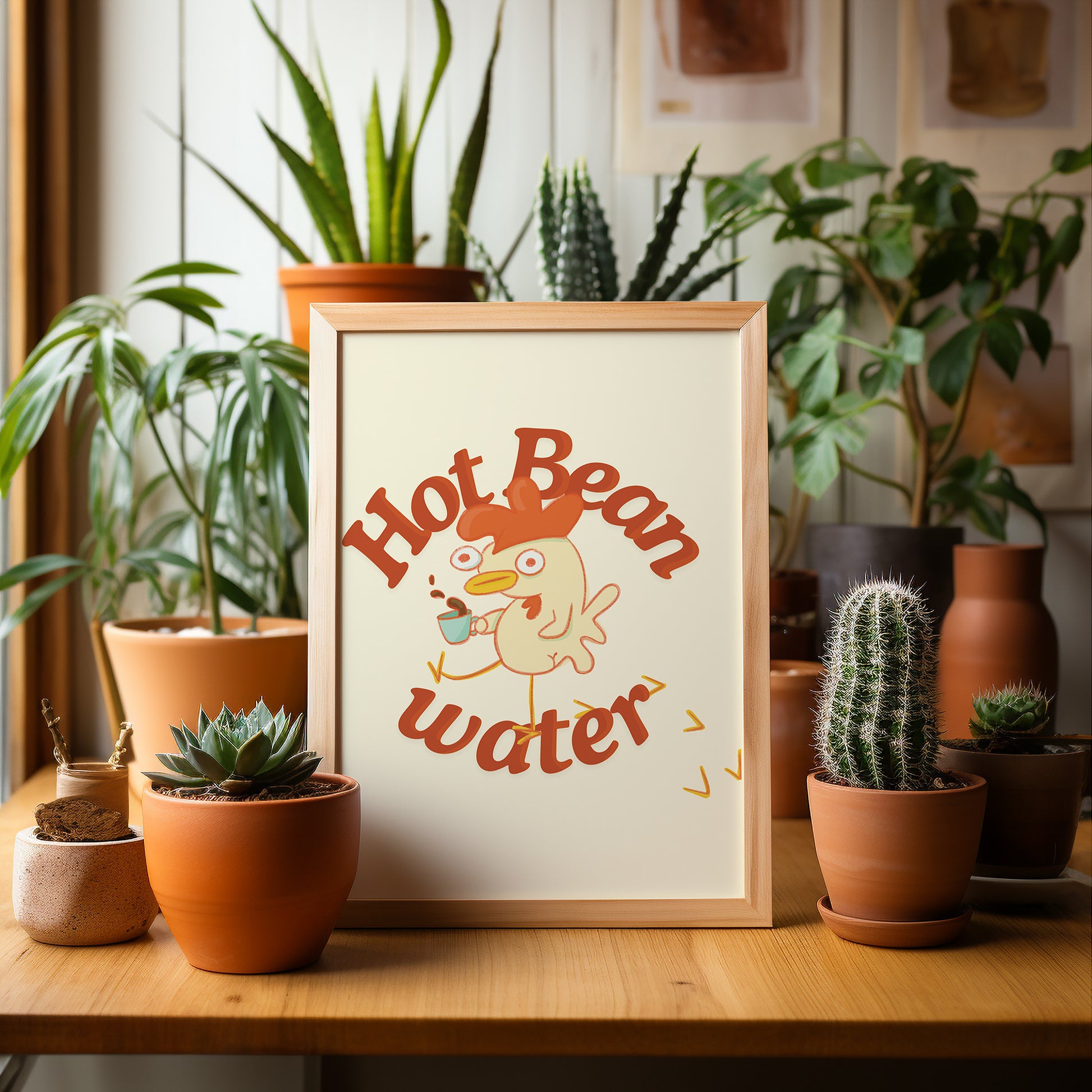 a funny coffee art print that features a chicken holding a cup of coffee next to text that reads &quot;hot bean water&quot; is displayed in a wooden frame next to a bunch of house plants