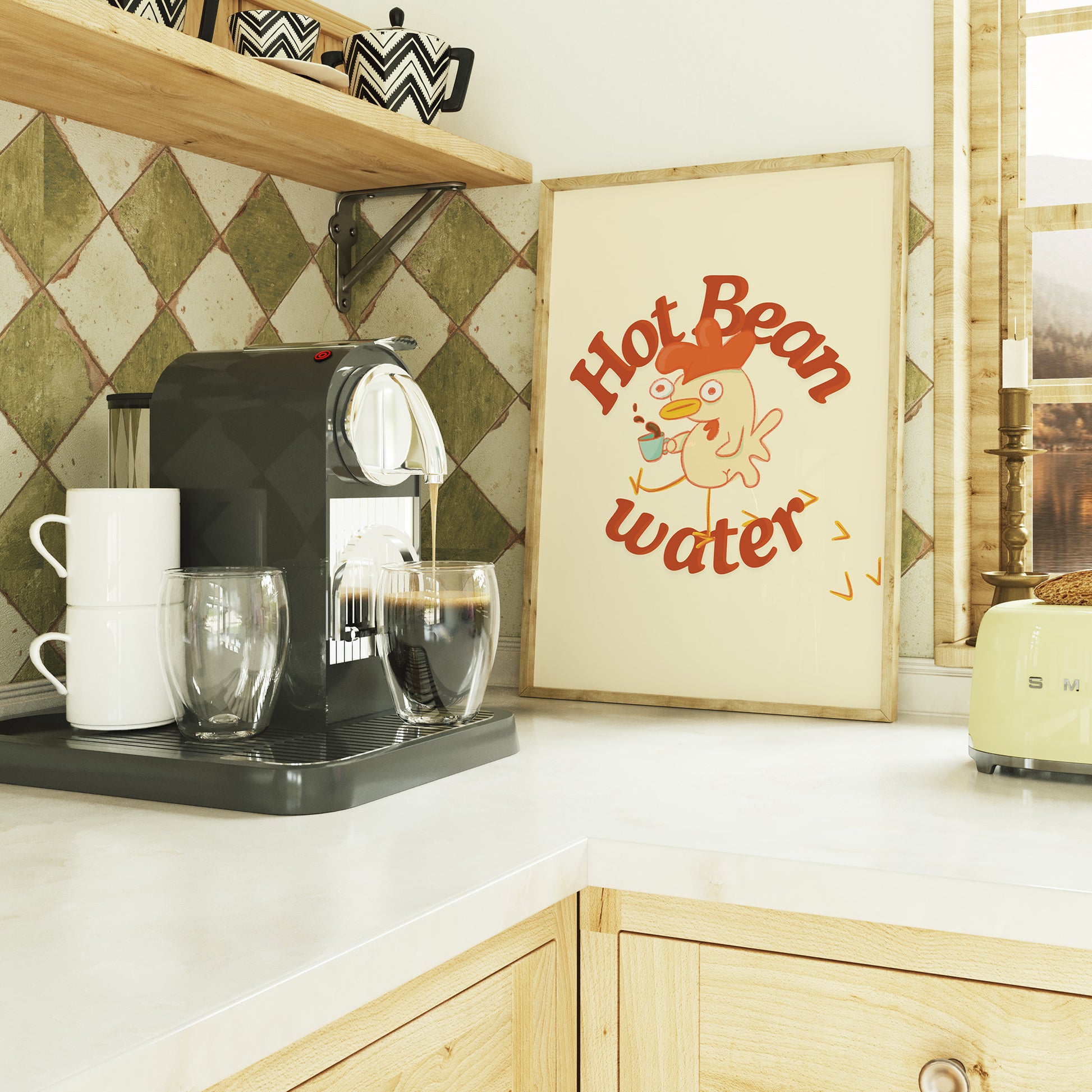 a funny coffee art print that features a chicken holding a cup of coffee next to text that reads &quot;hot bean water&quot; is framed and sitting on a trendy kitchen countertop next to an espresso machine