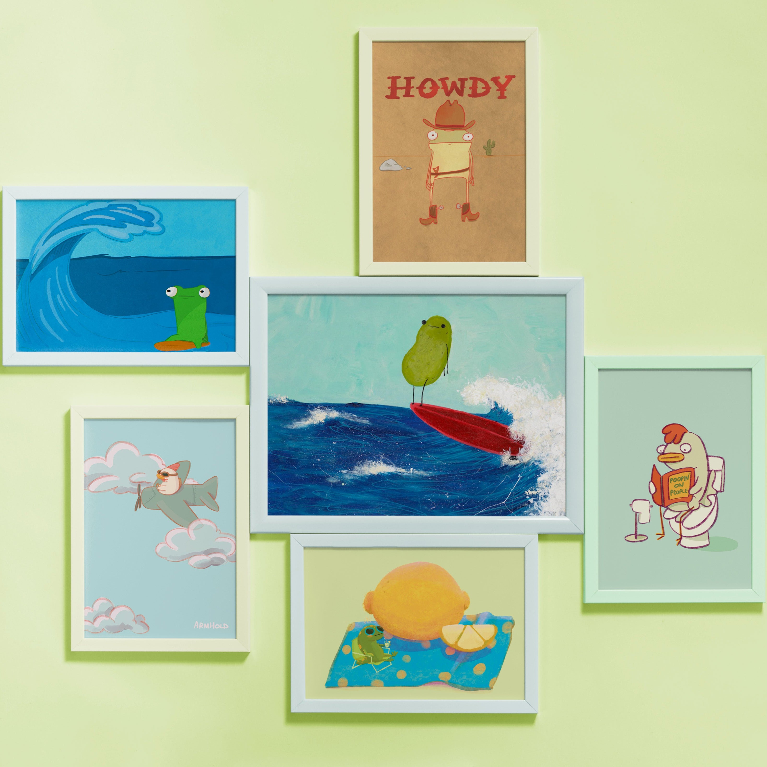 A gallery wall of framed whimsical character driven illustrations by artist Jennifer Armhold