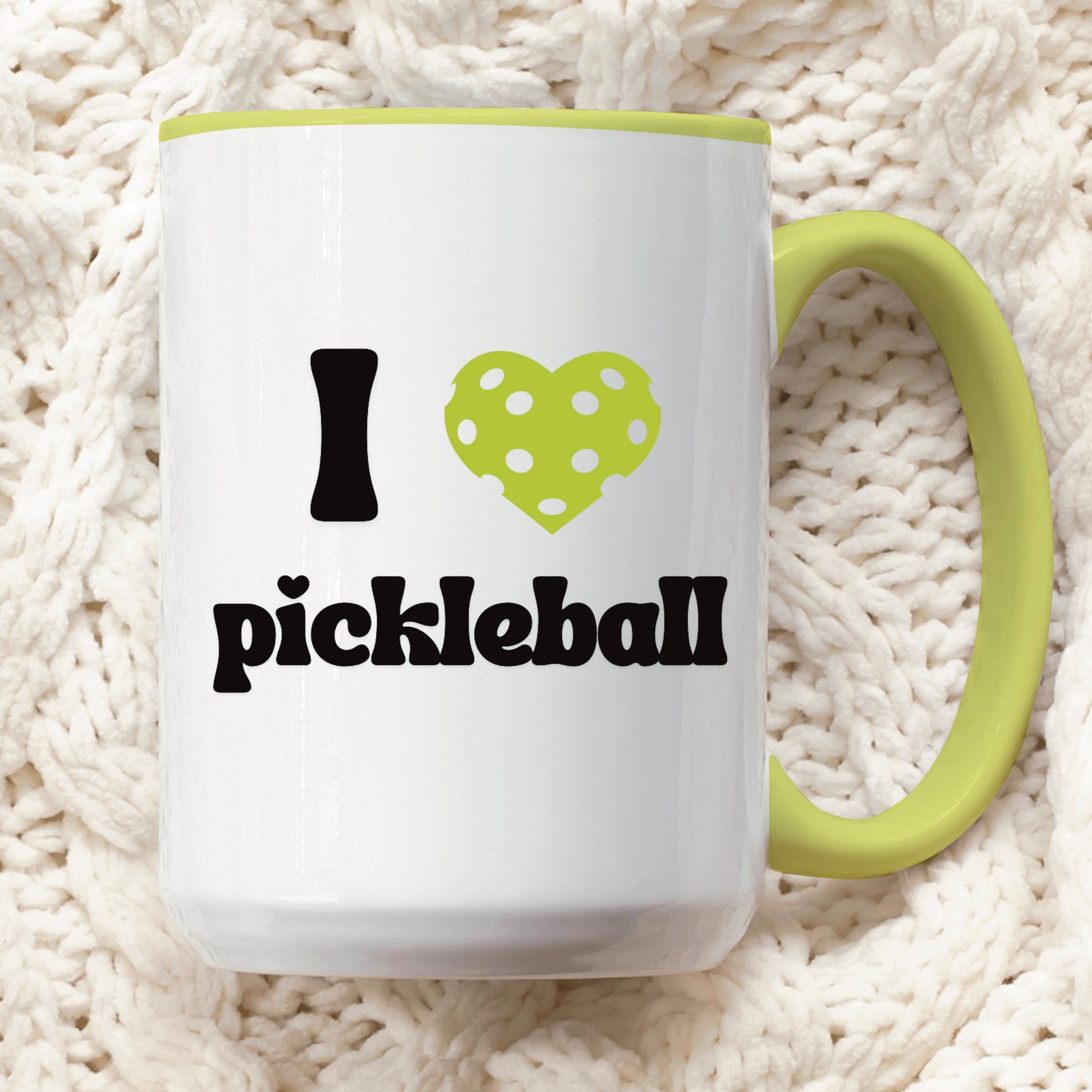 close up view of a pickle ball mug with a quote that says "I heart Pickleball" with green ceramic accents