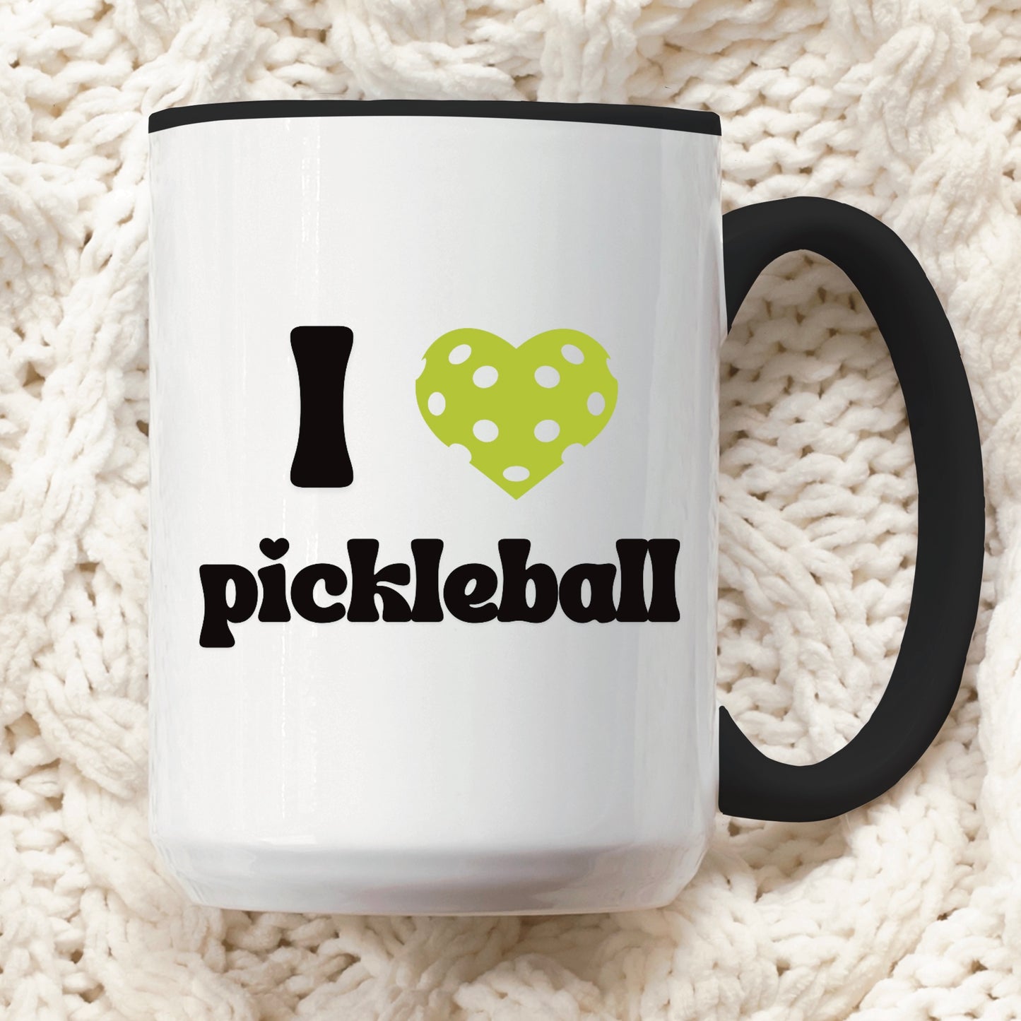 close up view of a pickleball mug with a quote that says "I heart Pickleball" with black ceramic accents