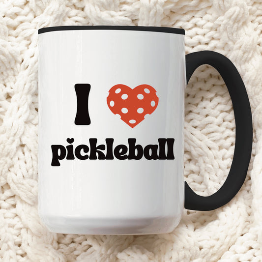 a pickle ball mug with a quote that says "I heart Pickleball" with black ceramic accents