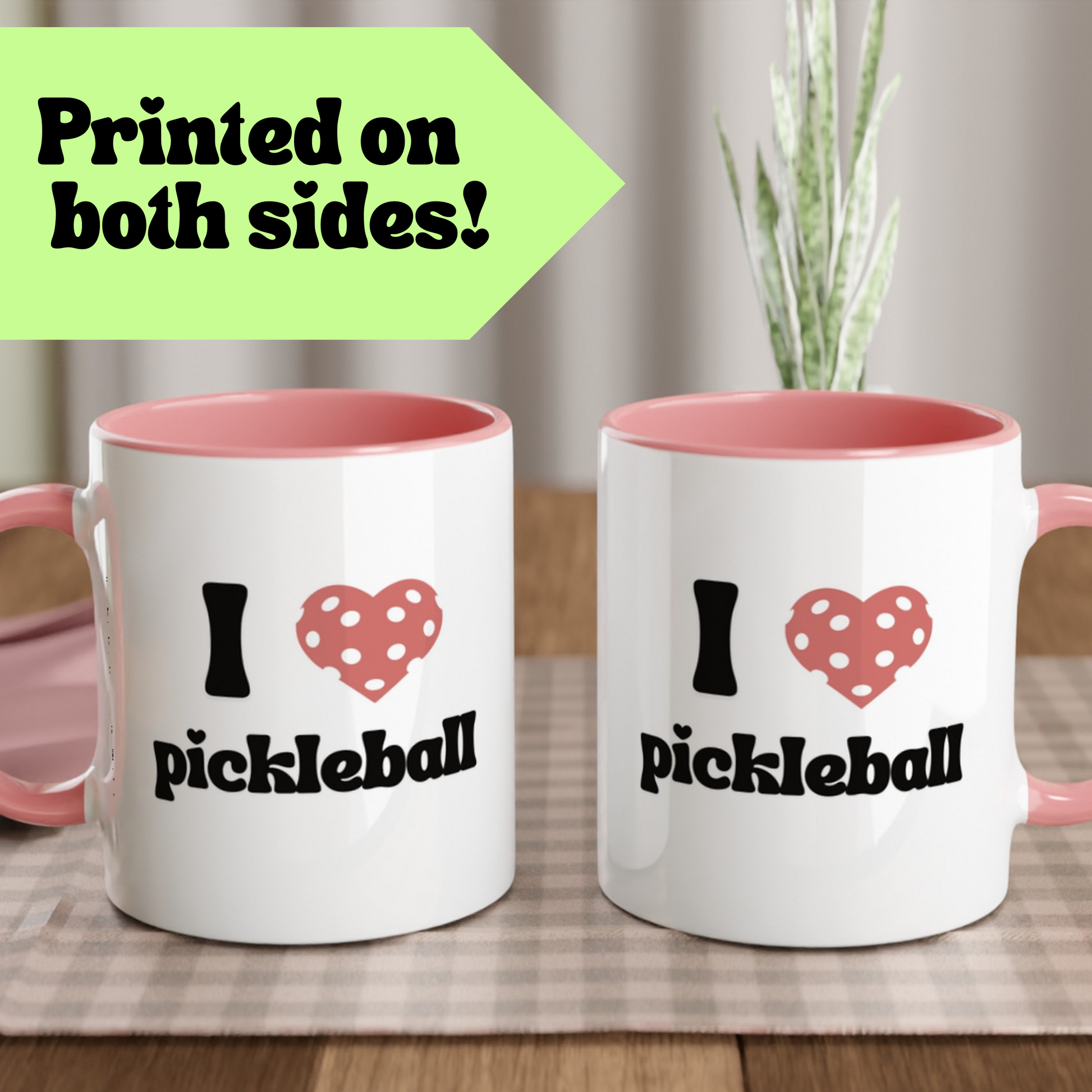 two sided view of a pickleball mug with a quote that says "I heart pickleball" with illustration of pink pickleball shaped heart