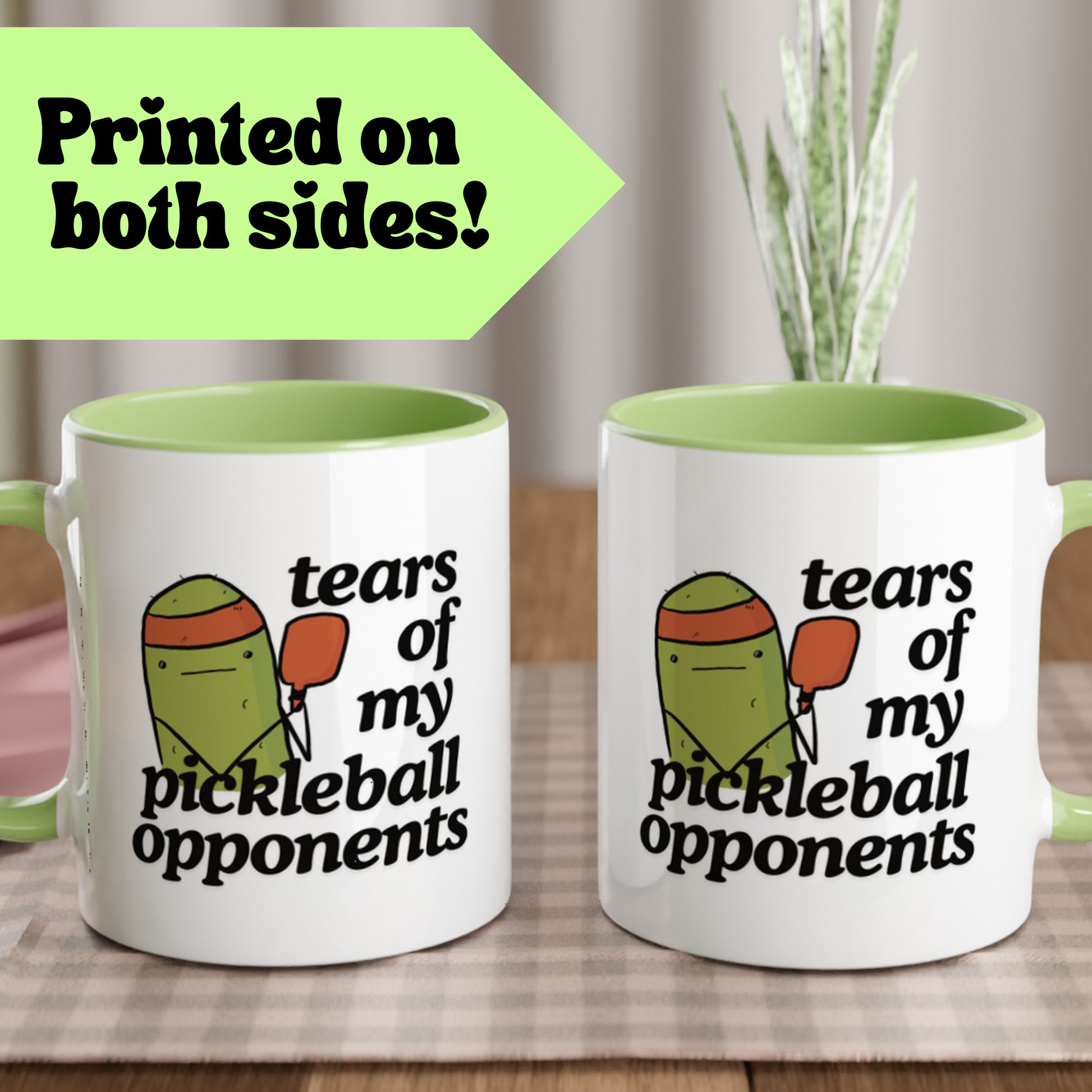 front view a pickleball mug with a quote that says "tears of my pickleball opponents" with cute illustration of a pickle holding a red pickleball paddle