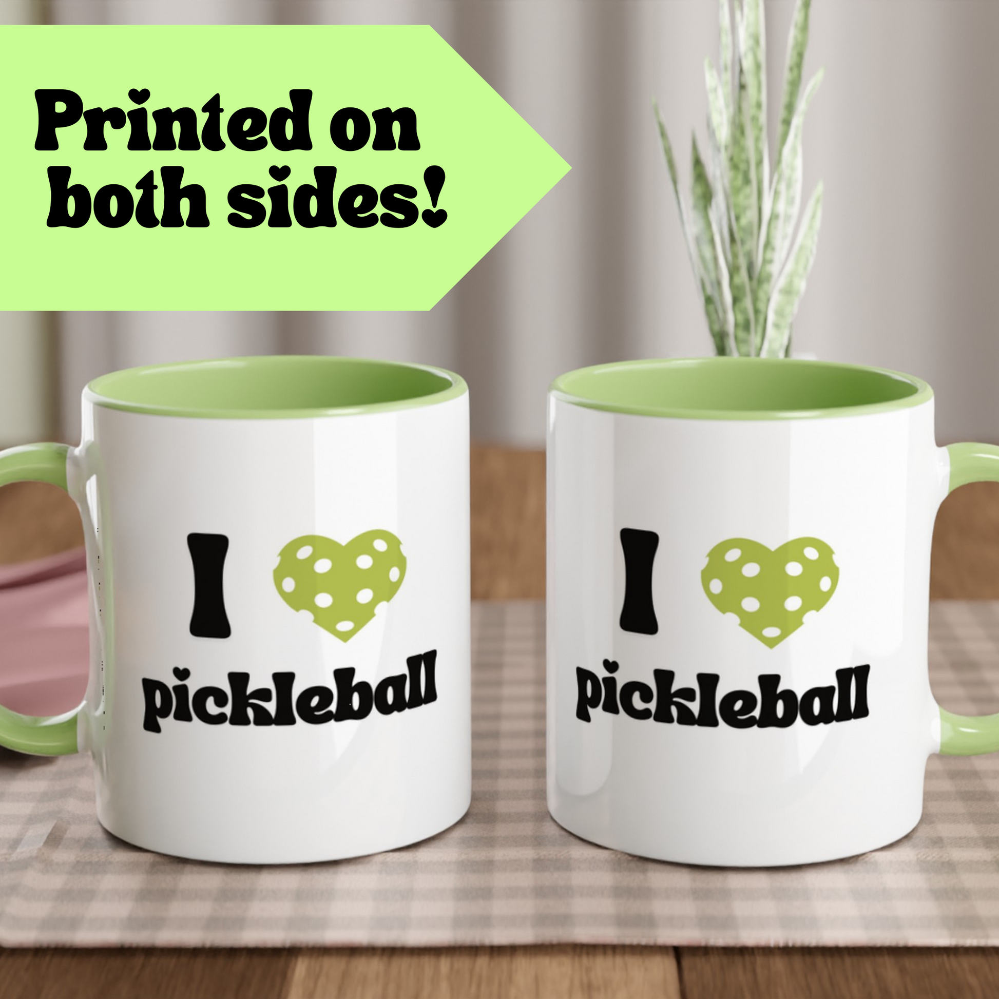 close up view of a pickleball mug with a quote that says "I heart Pickleball" with green ceramic accents printed on both sides