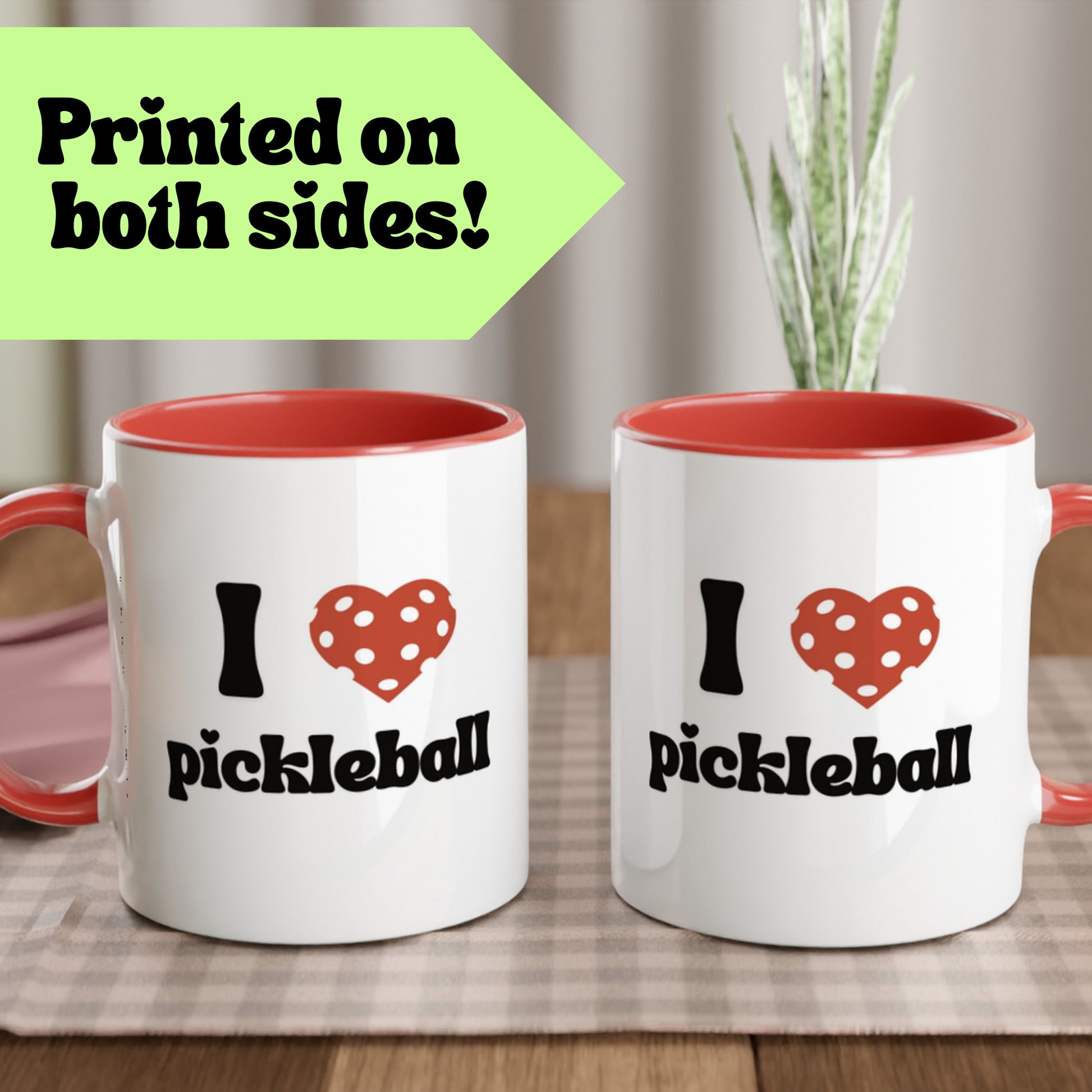 close up view of a pickle ball mug with a quote that says "I heart Pickle ball" with red ceramic accents