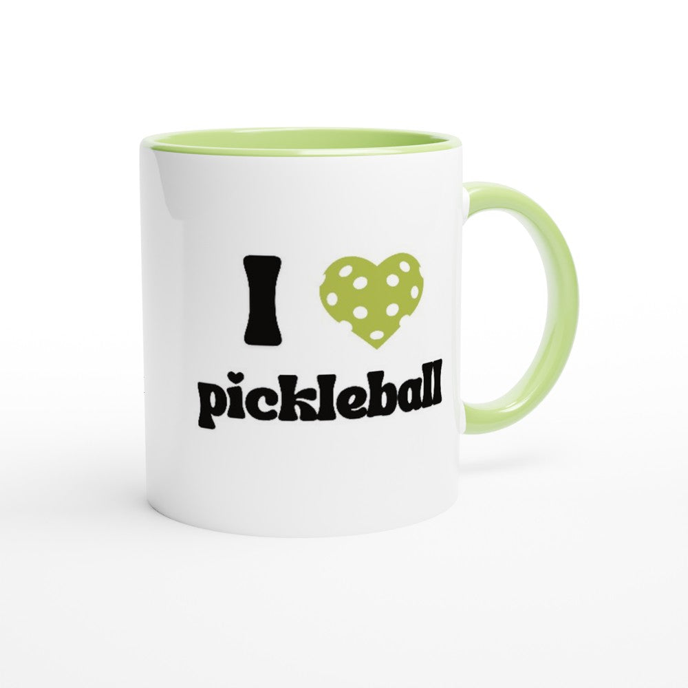 close up view of a pickle ball mug with a quote that says "I heart Pickle ball" with green ceramic accents