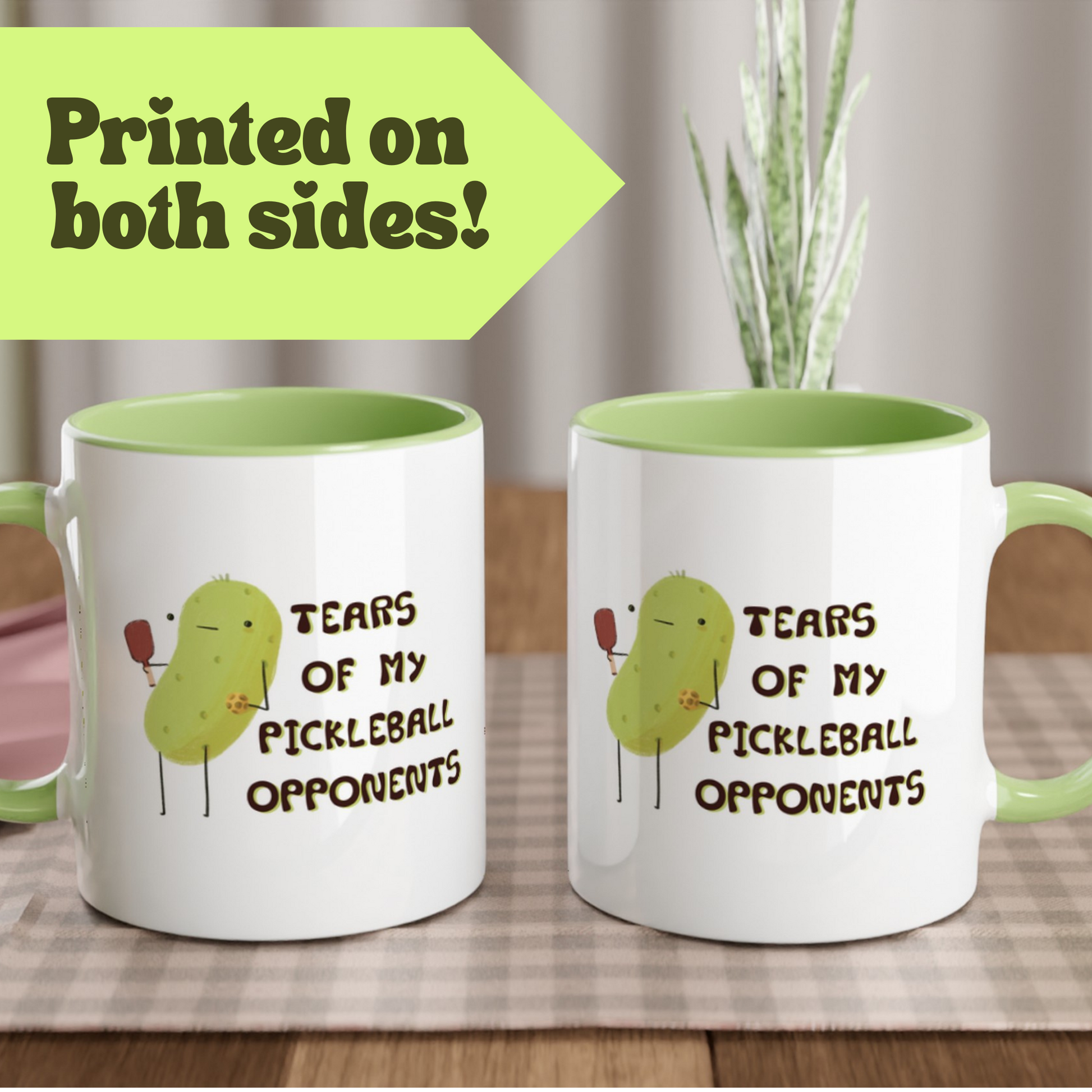 two sided view of a pickleball mug with funny quote that says "tears of my pickleball opponents" next to illustration of a pickle holding a pickleball and paddle