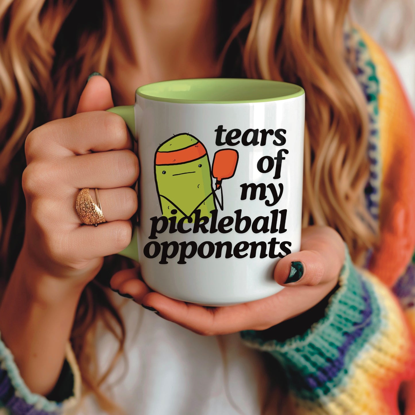 image of a woman holding a pickleball mug with a quote that says "tears of my pickleball opponents" with cute illustration of a pickle holding a red pickleball paddle