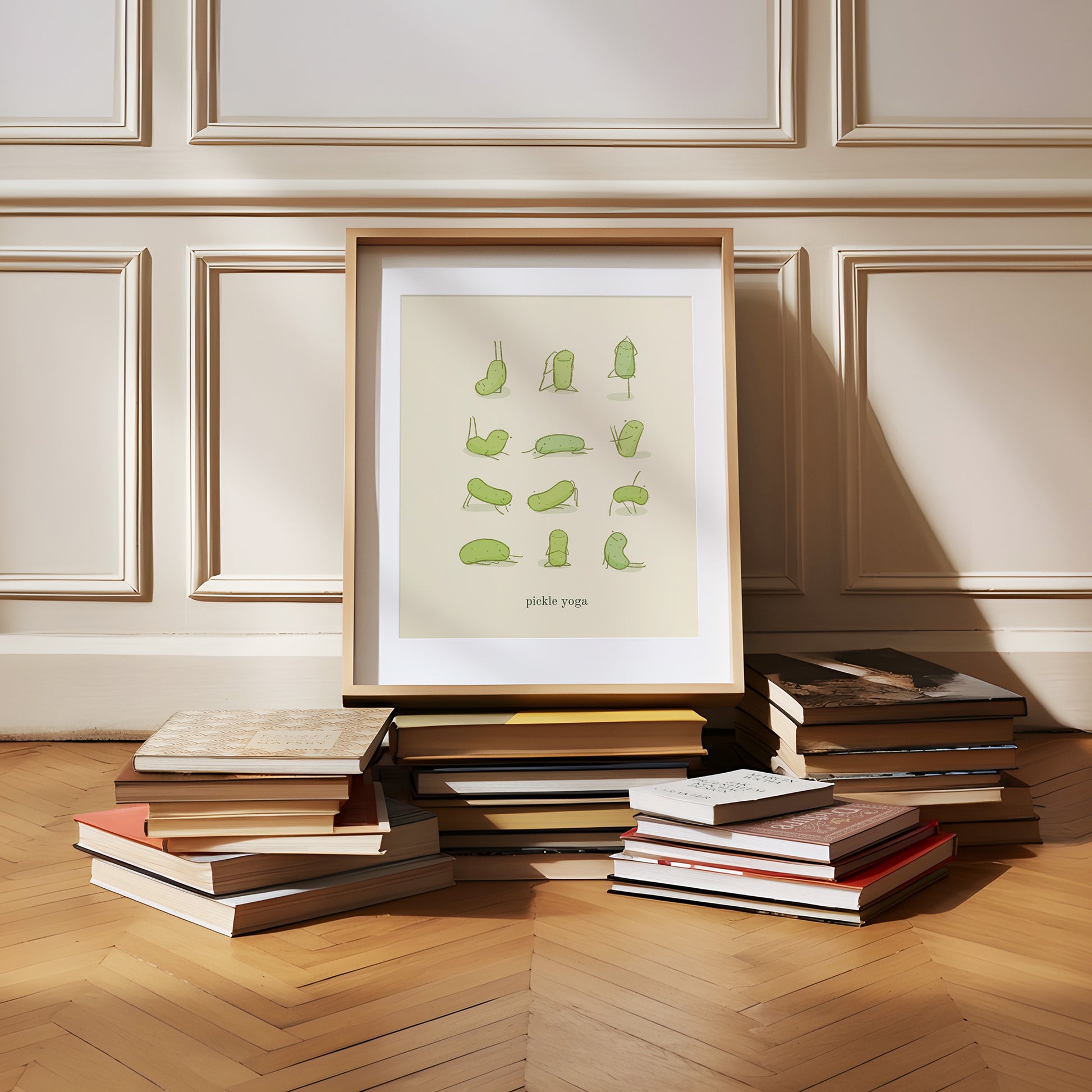 a funny pickle art print features a cute pickle in various yoga poses over text at the bottom that reads &quot;pickle yoga&quot; is displayed in a wooden frame that is resting on a pile of books