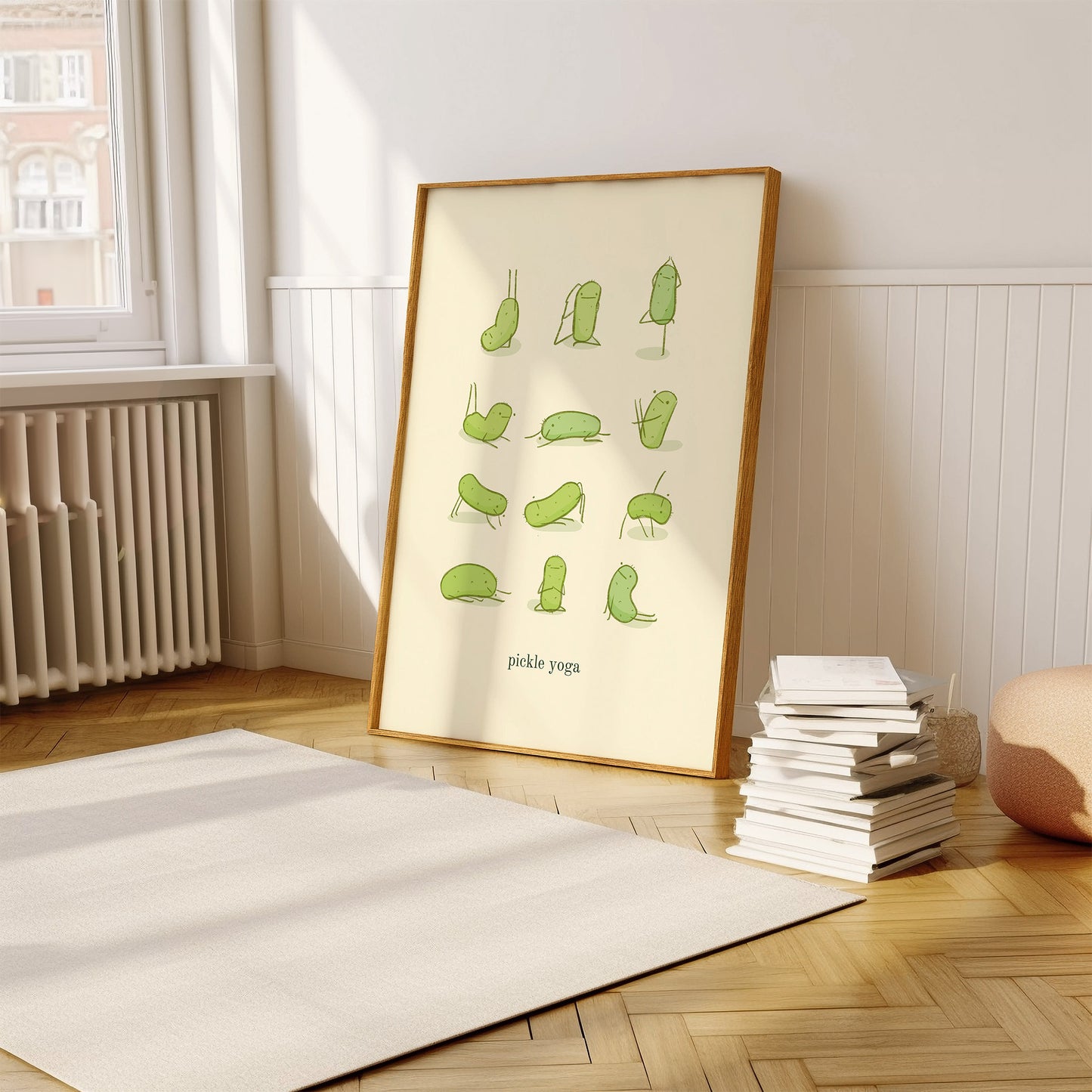 a funny pickle art print features a cute pickle in various yoga poses over text at the bottom that reads &quot;pickle yoga&quot; is displayed in a wooden frame that is leaning against the wall